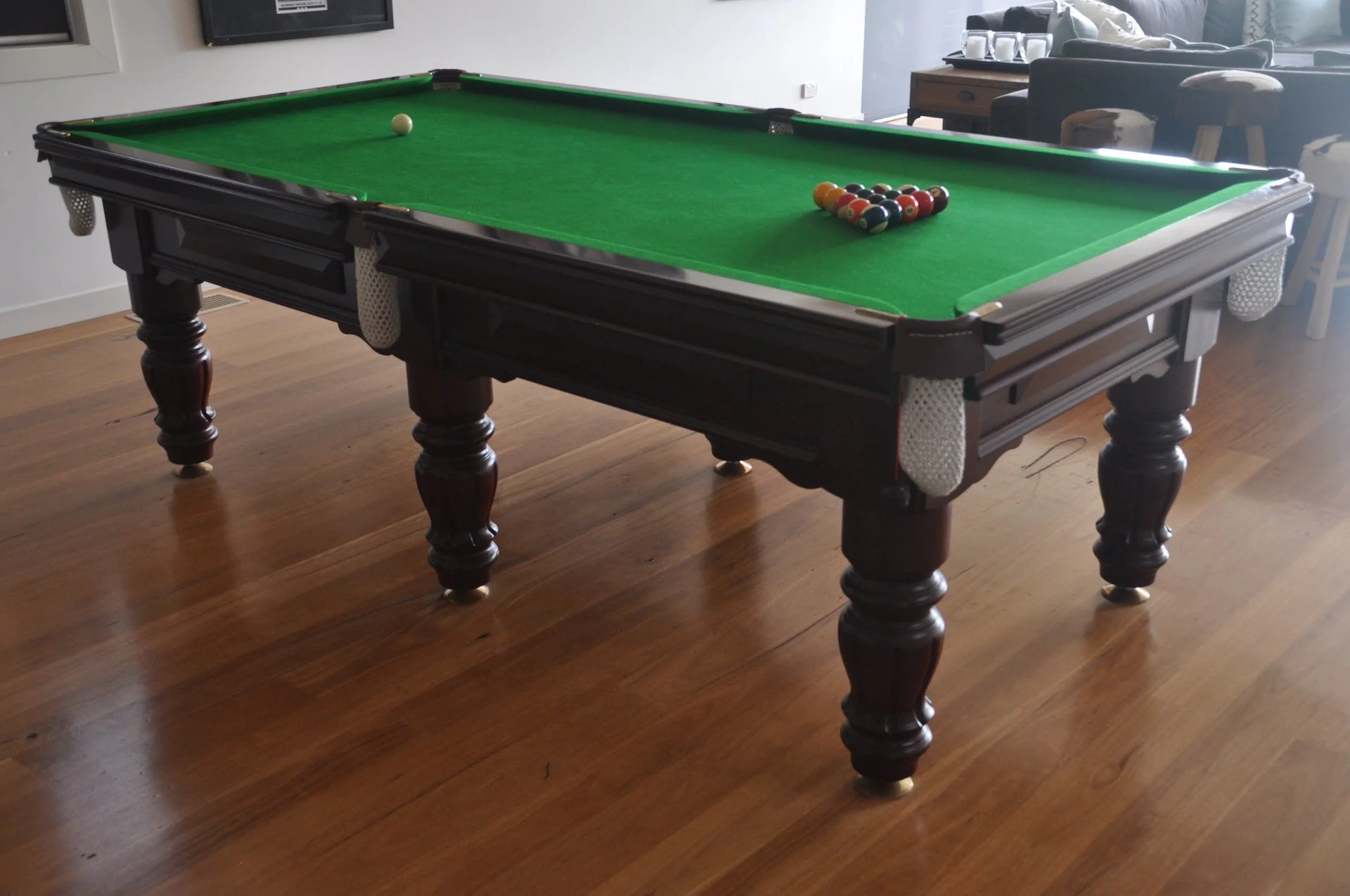A pool table ready to play with Blackbutt flooring underneath