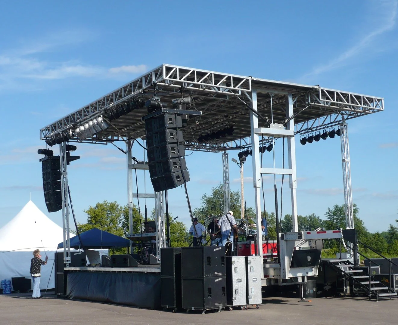 A stage with speakers and trusses