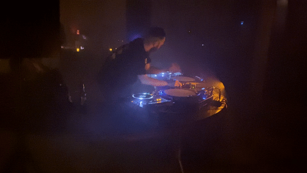 GIF of DJ mixing at a party
