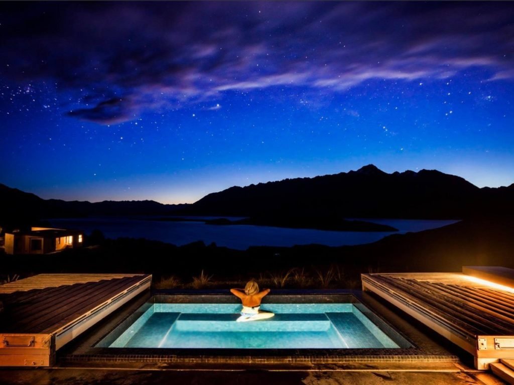 Women in spa overlooking lake at Aro Ha in New Zealand