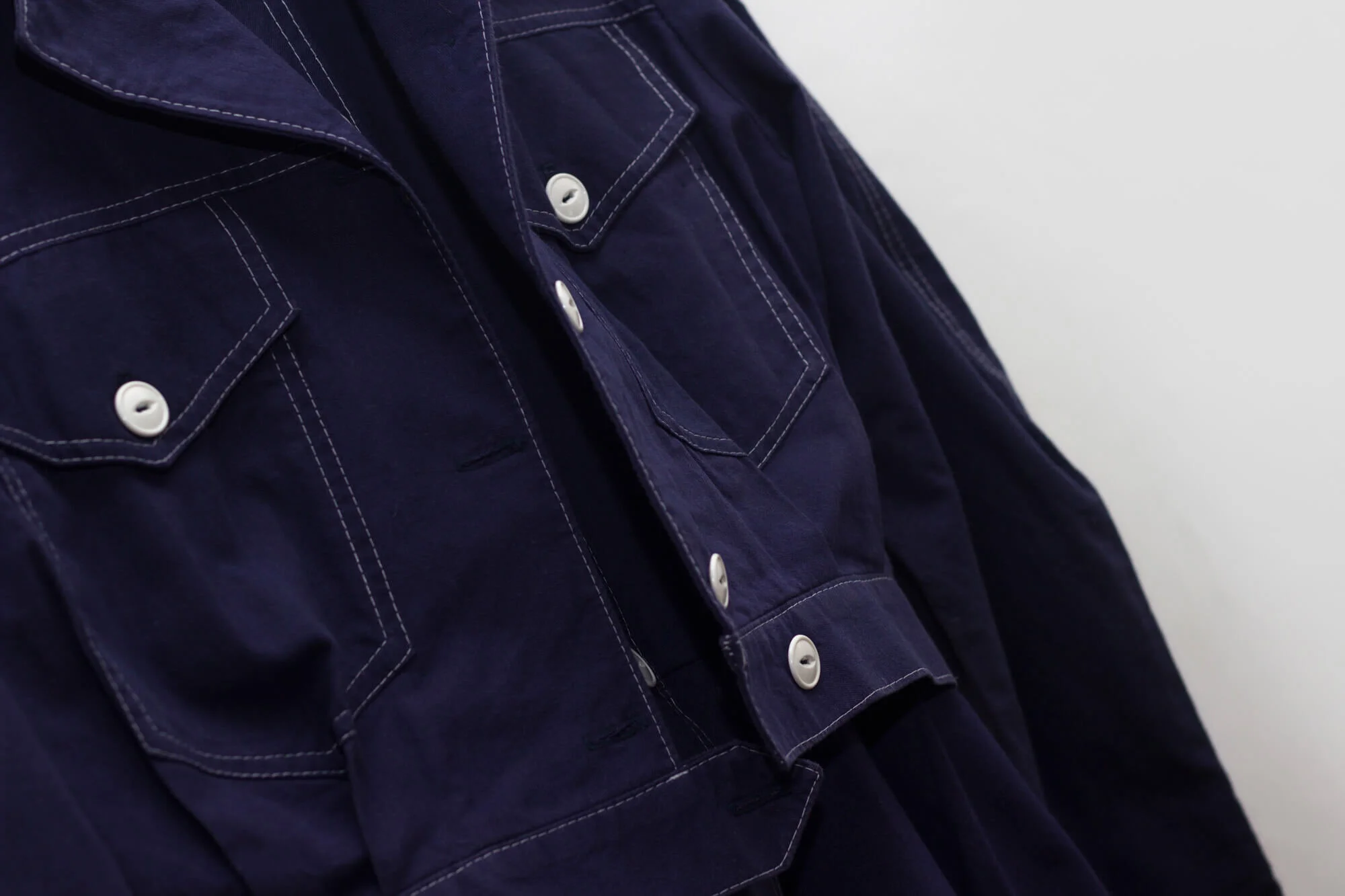 Front detail of Order Materia's Women’s Indigo Sleeveless Dress and Jacket.