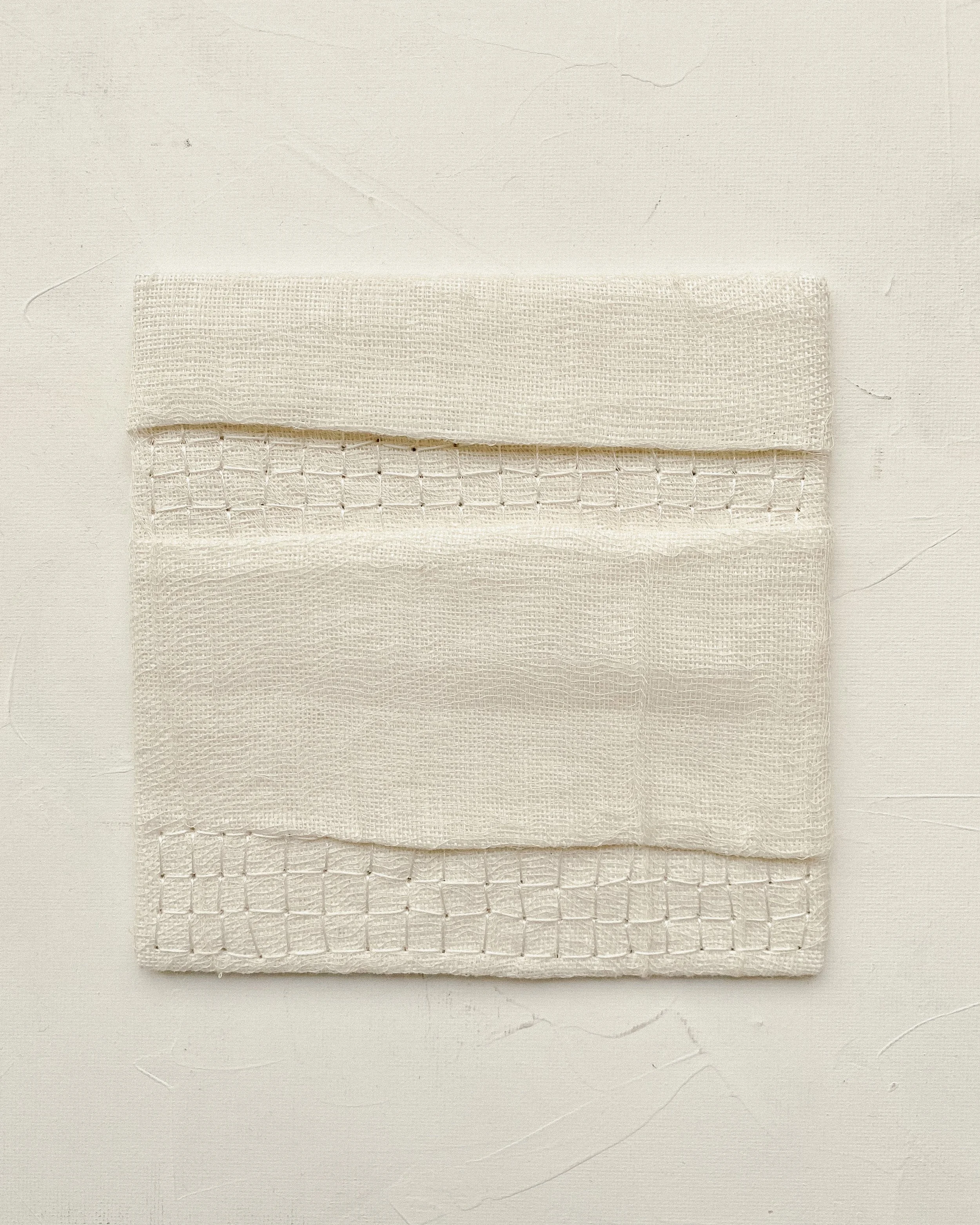 Textile wall art unframed, dimensions are 15 by 15 centimeters.