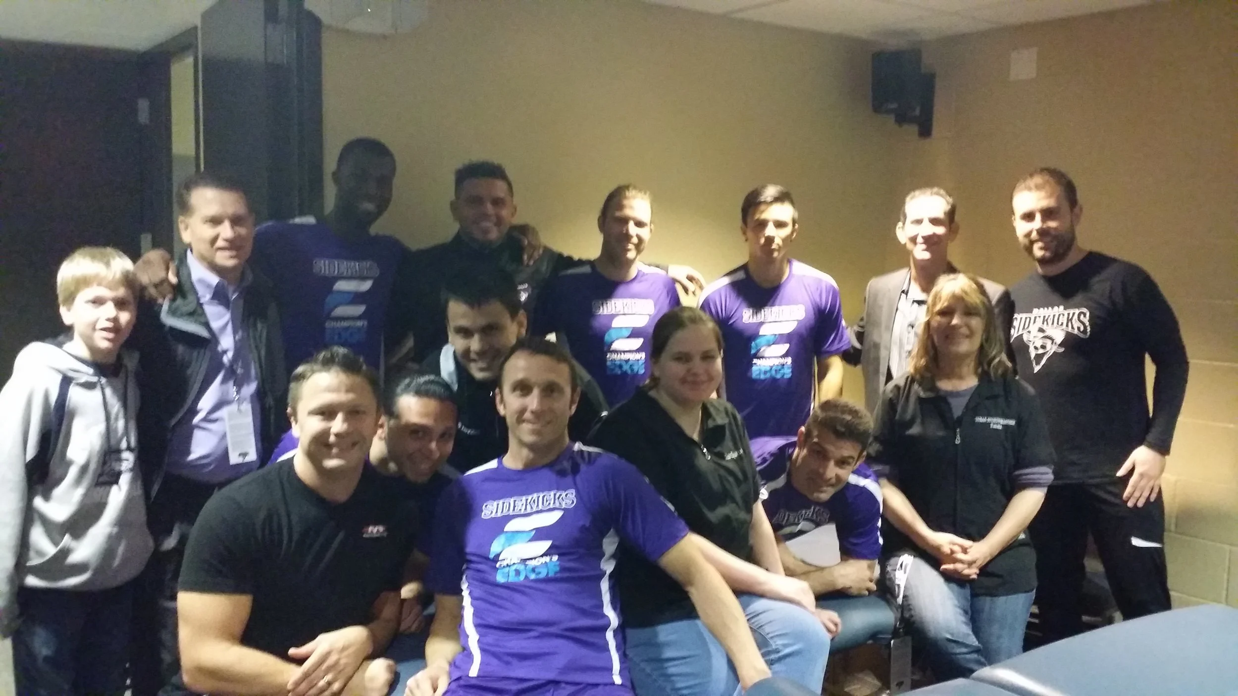 A group of people who were Emma Anderson's colleagues, some wearing purple sports shirts with 
