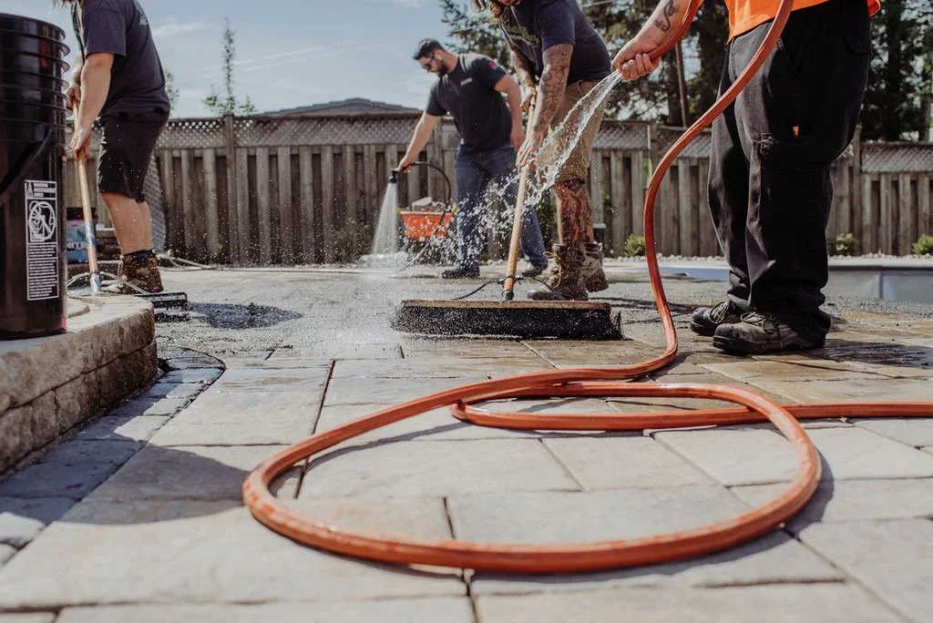 Image of contractors watering Gator Nitro resin sand
