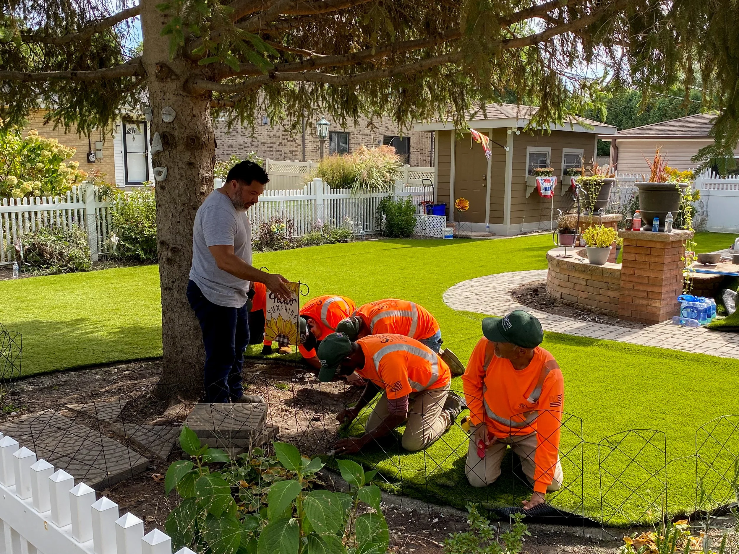 installers laying artificial turf