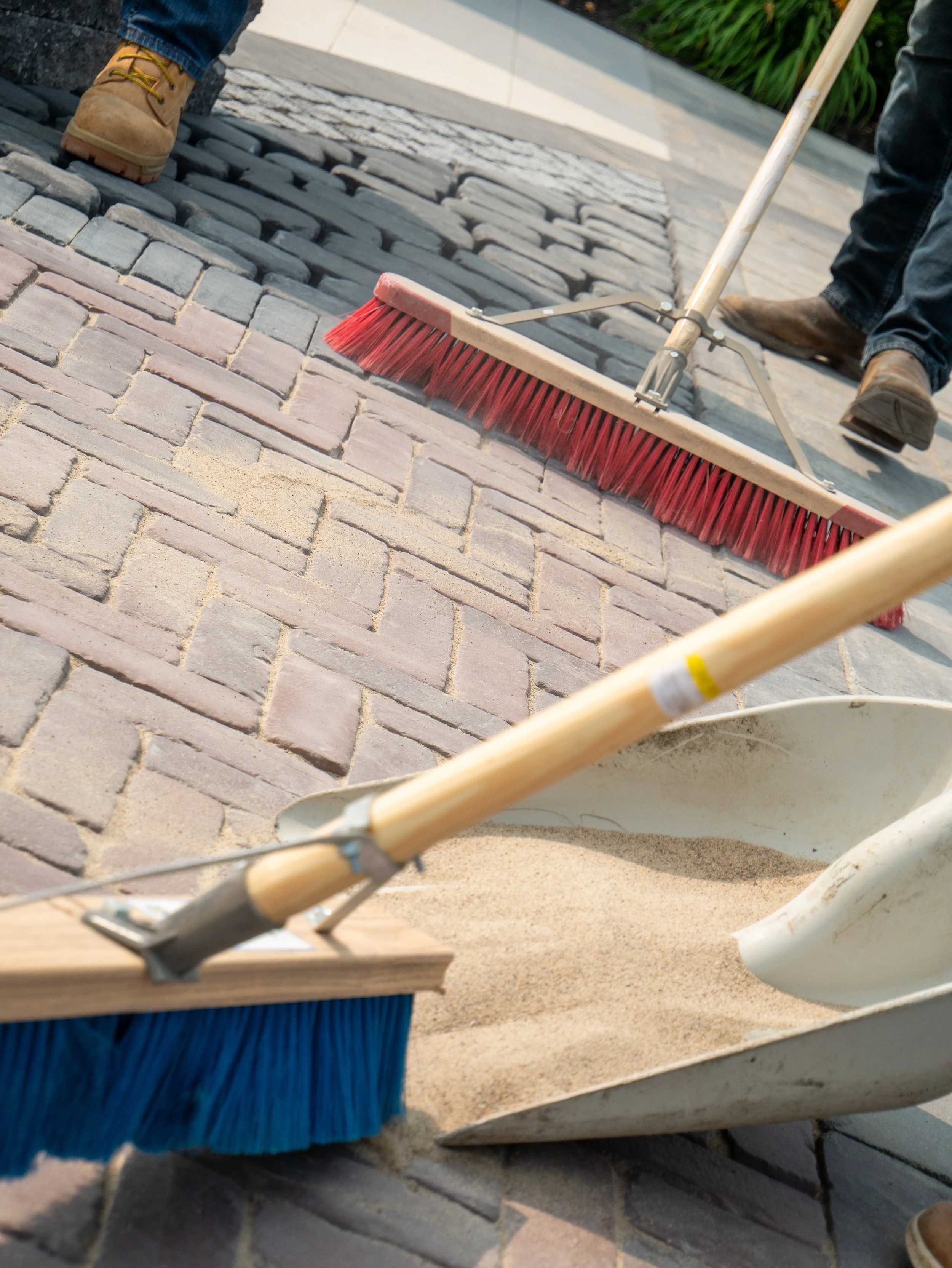 Sweeping polymeric sand into paver joints