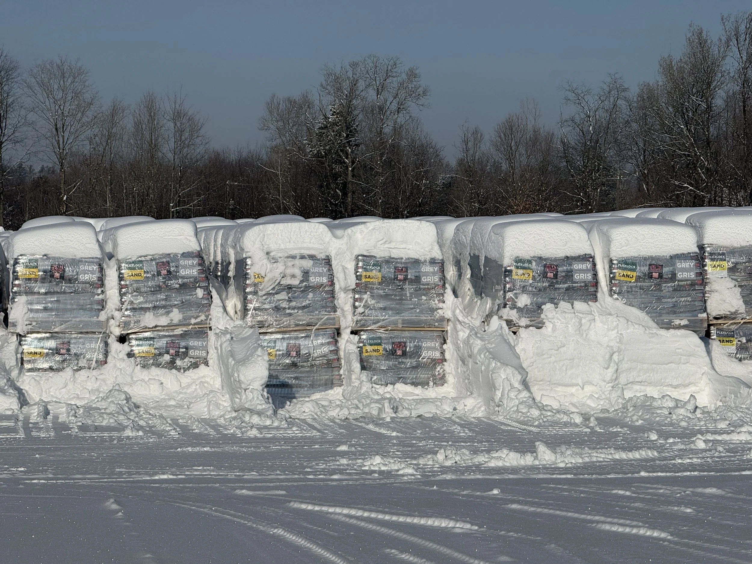 Pallets of polymeric sand stored outside in the winter
