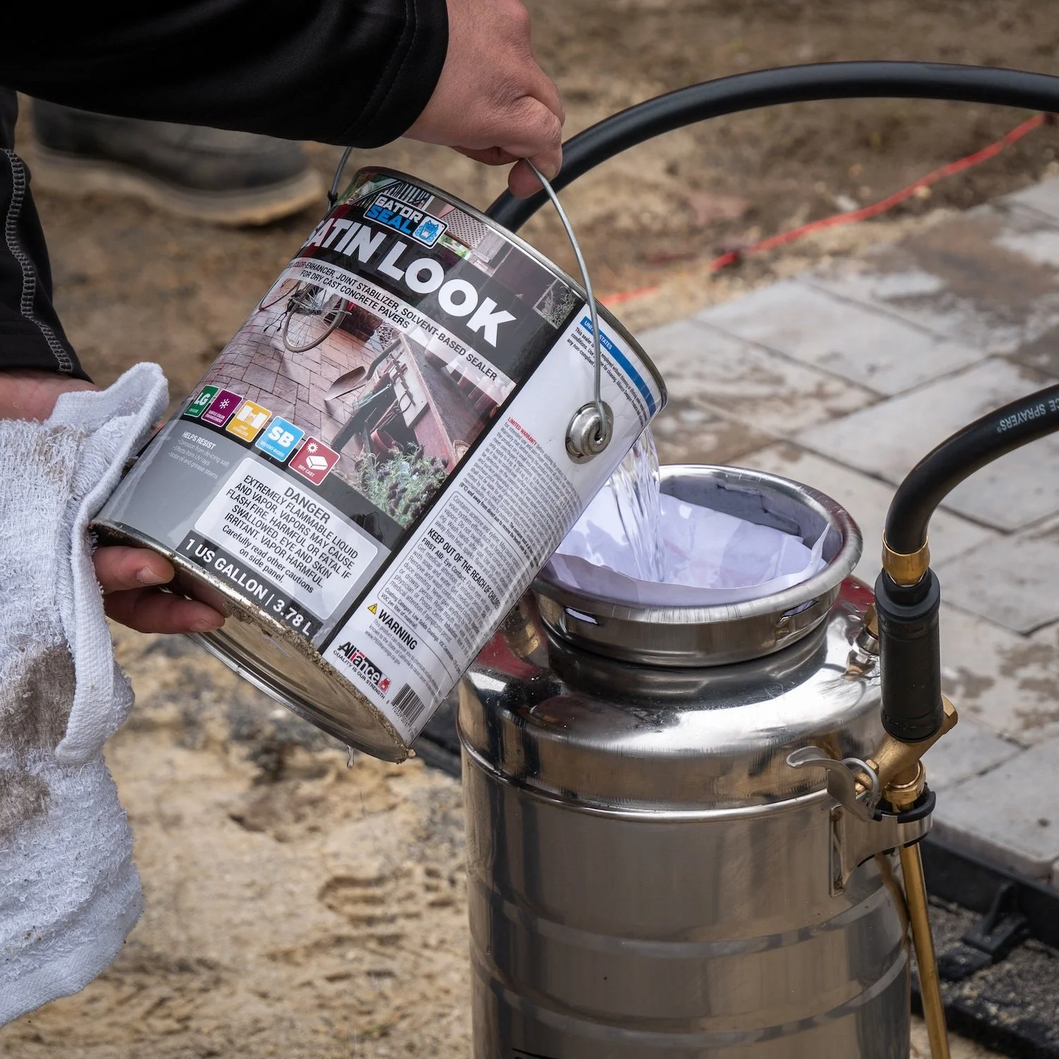Solvent-based sealer being poured into a sprayer