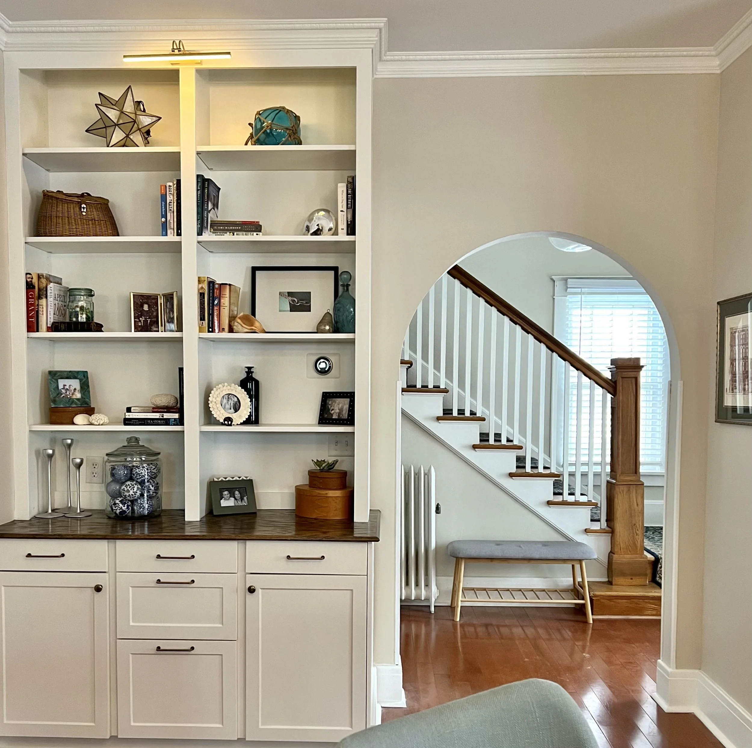 Spacious and attractive bookshelf installation including overhead lighting, granite countertop, and cabinet/ drawer storage.
