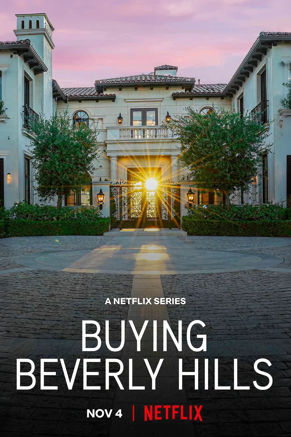 Front view of a luxurious mansion with a gated entrance, two trees, and a sunset. The scene promotes the Netflix series 'Buying Beverly Hills' premiering on November 4.