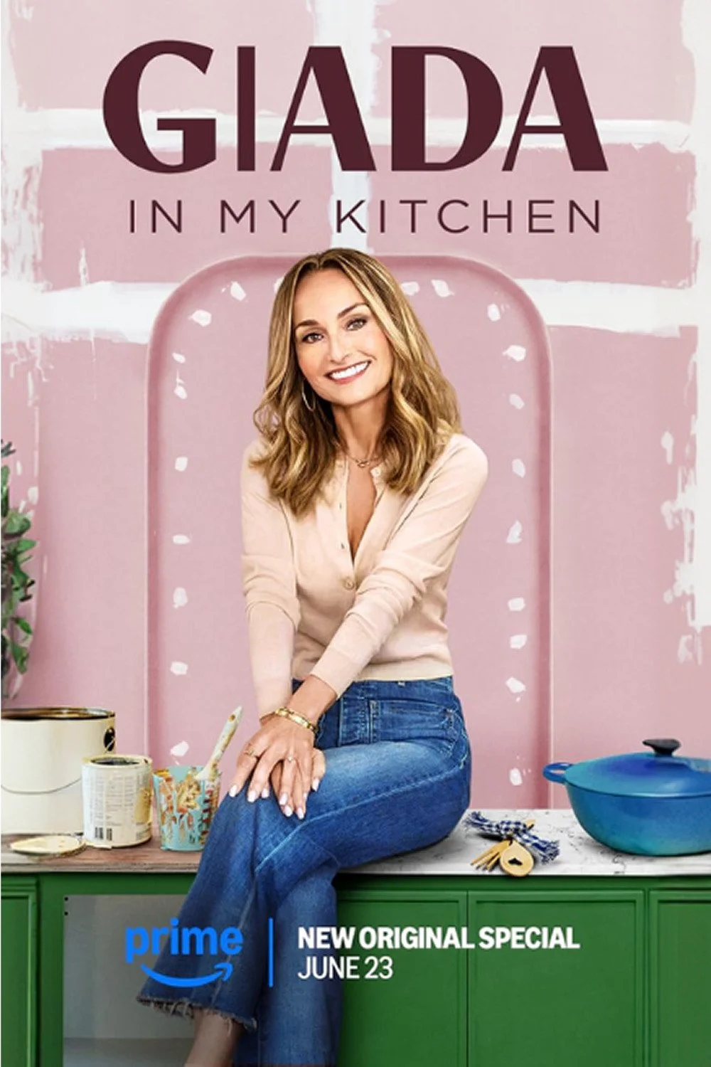 Poster for the Amazon Prime show 'Giada in My Kitchen' featuring Giada De Laurentiis leaning on a kitchen counter with a pink background, green cabinets, and a blue pot, promoting a new special airing on June 23.