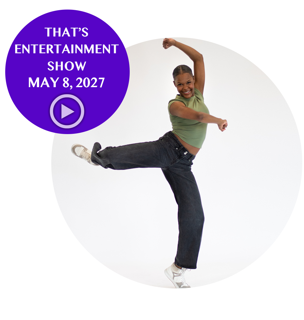 A smiling dancer with a green shirt and black jeans dancing with one leg kicked up and her arm raised, with a purple text overlay announcing an entertainment show on May 8, 2027.