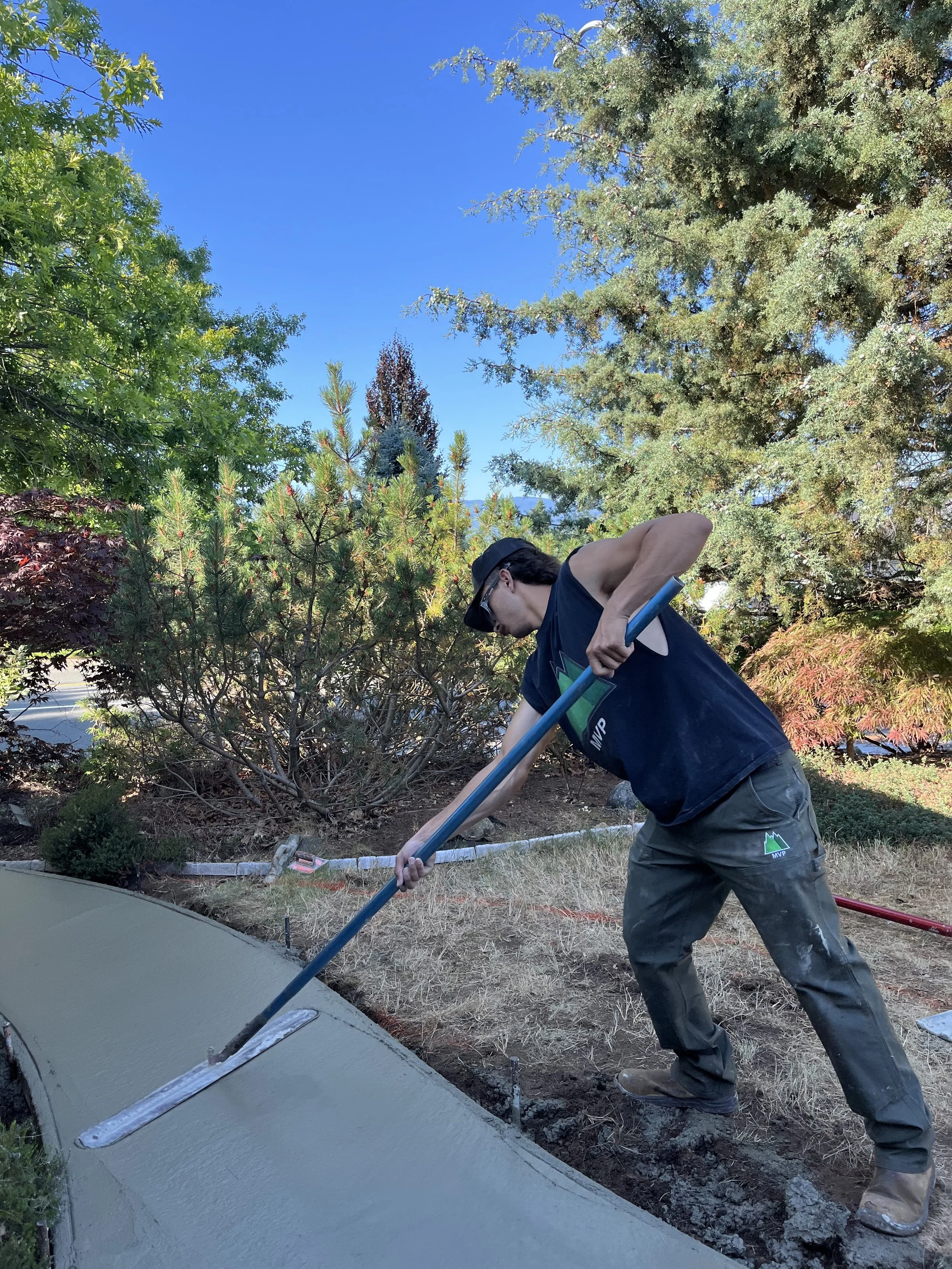 MVP crew finishing a concrete pathway