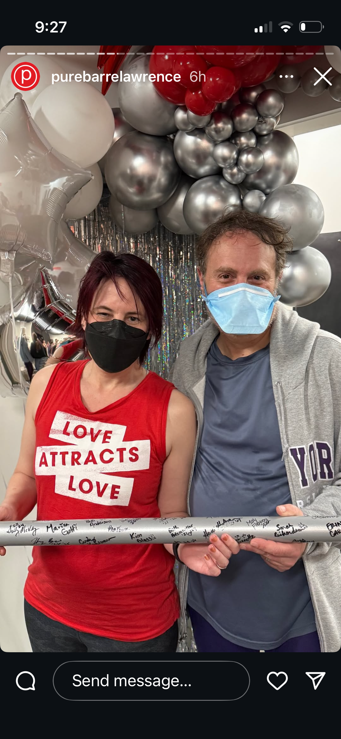 screenshot of Pure Barre Lawrence post celebrating Platinum barre achievement in 2025, featuring Jane alongside Henry, both of whom are masked and holding a silver barre. 