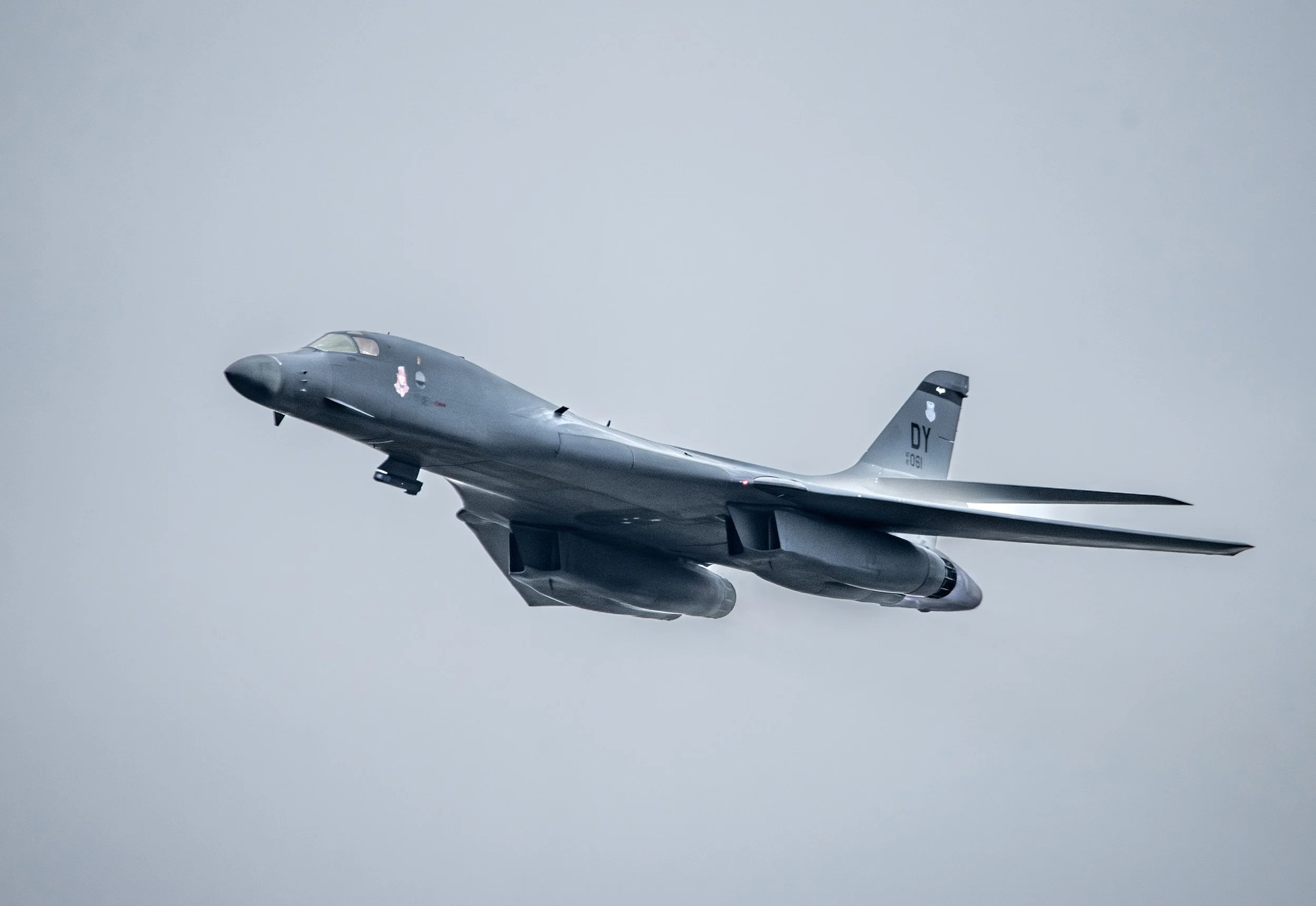 A military fighter jet flying in the sky.