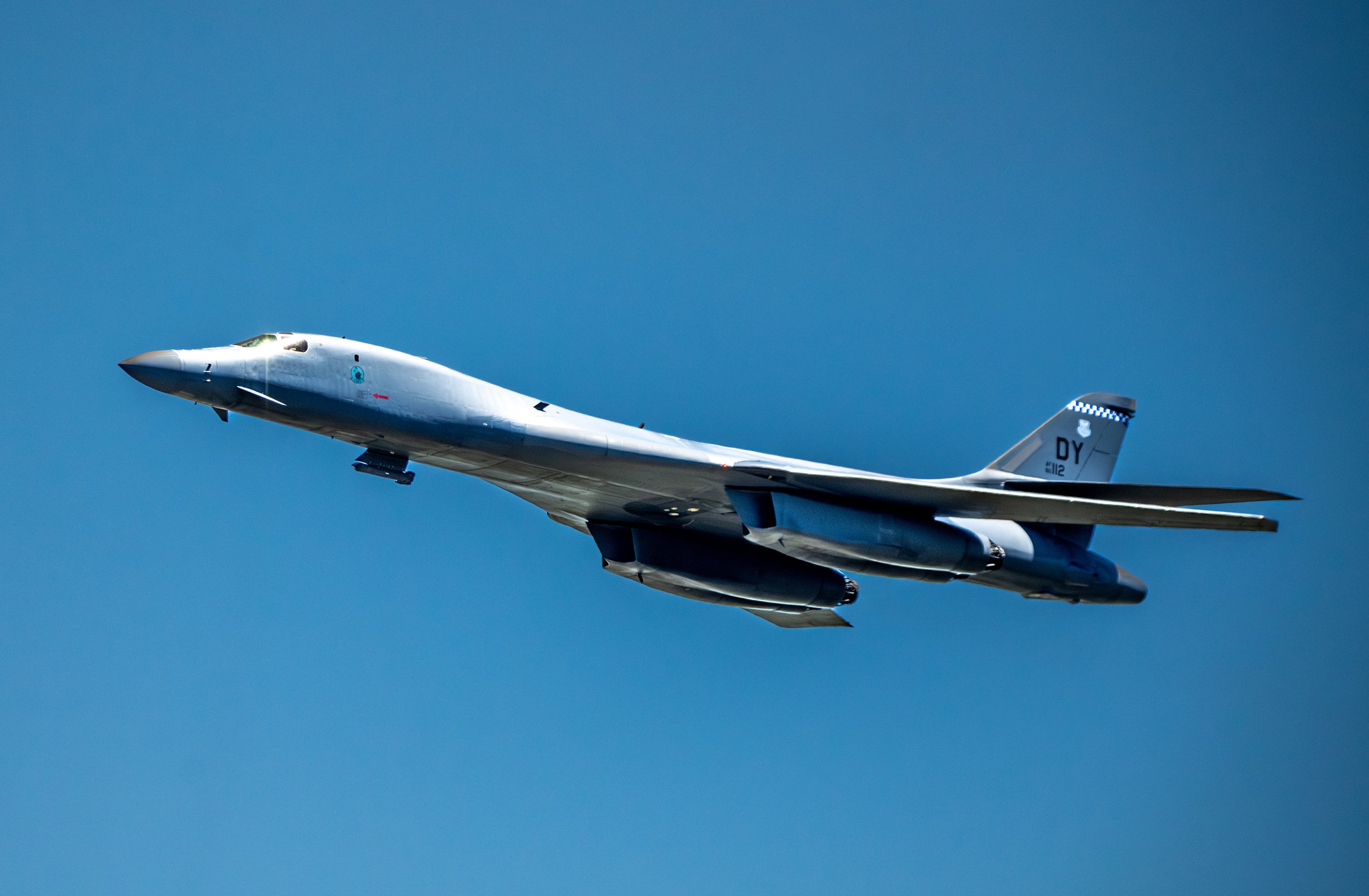 A military fighter jet flying in the sky during daytime.