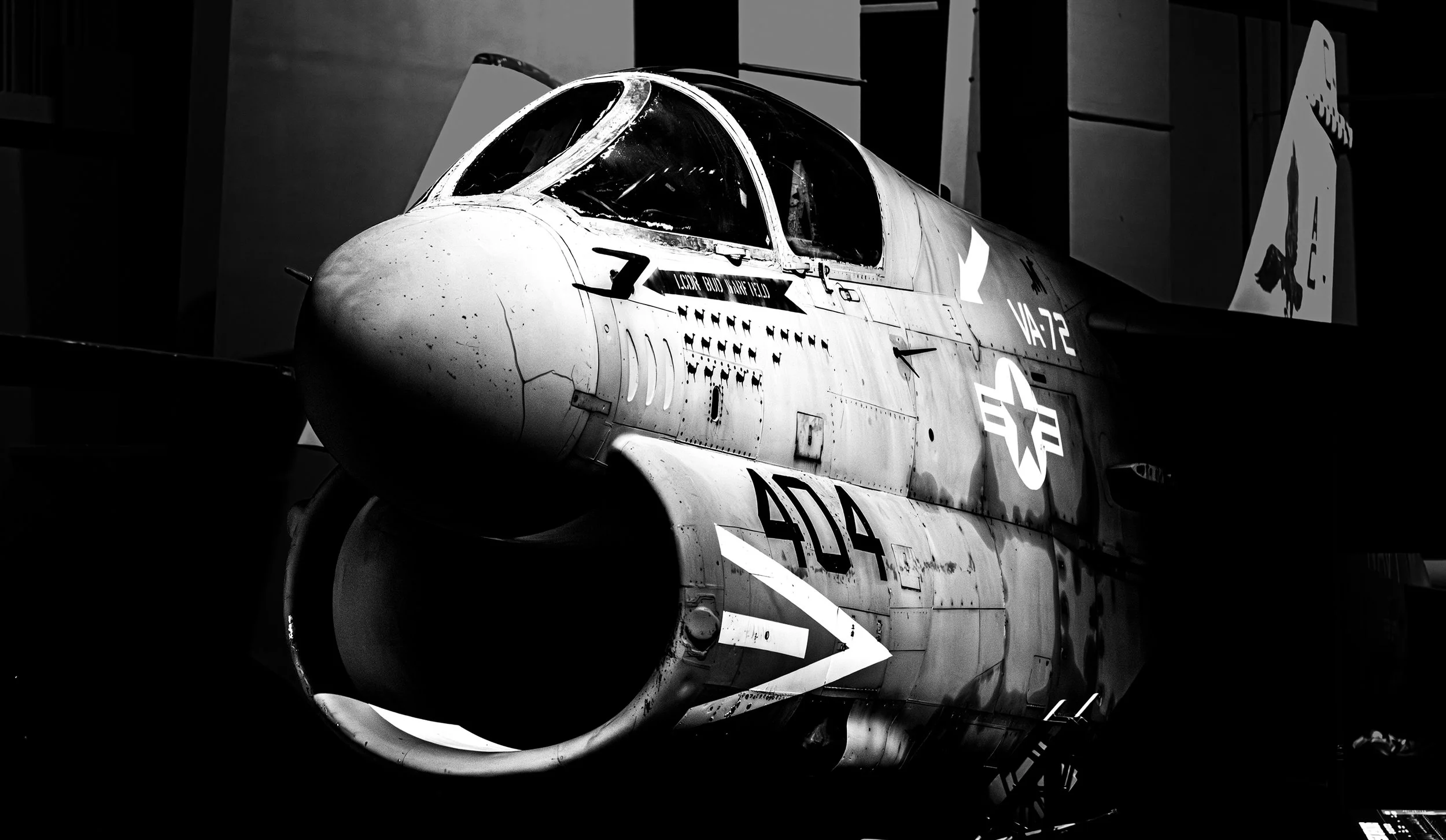 Black and white photograph of a military fighter jet aircraft on display, showing the front and side with visible markings and insignia.