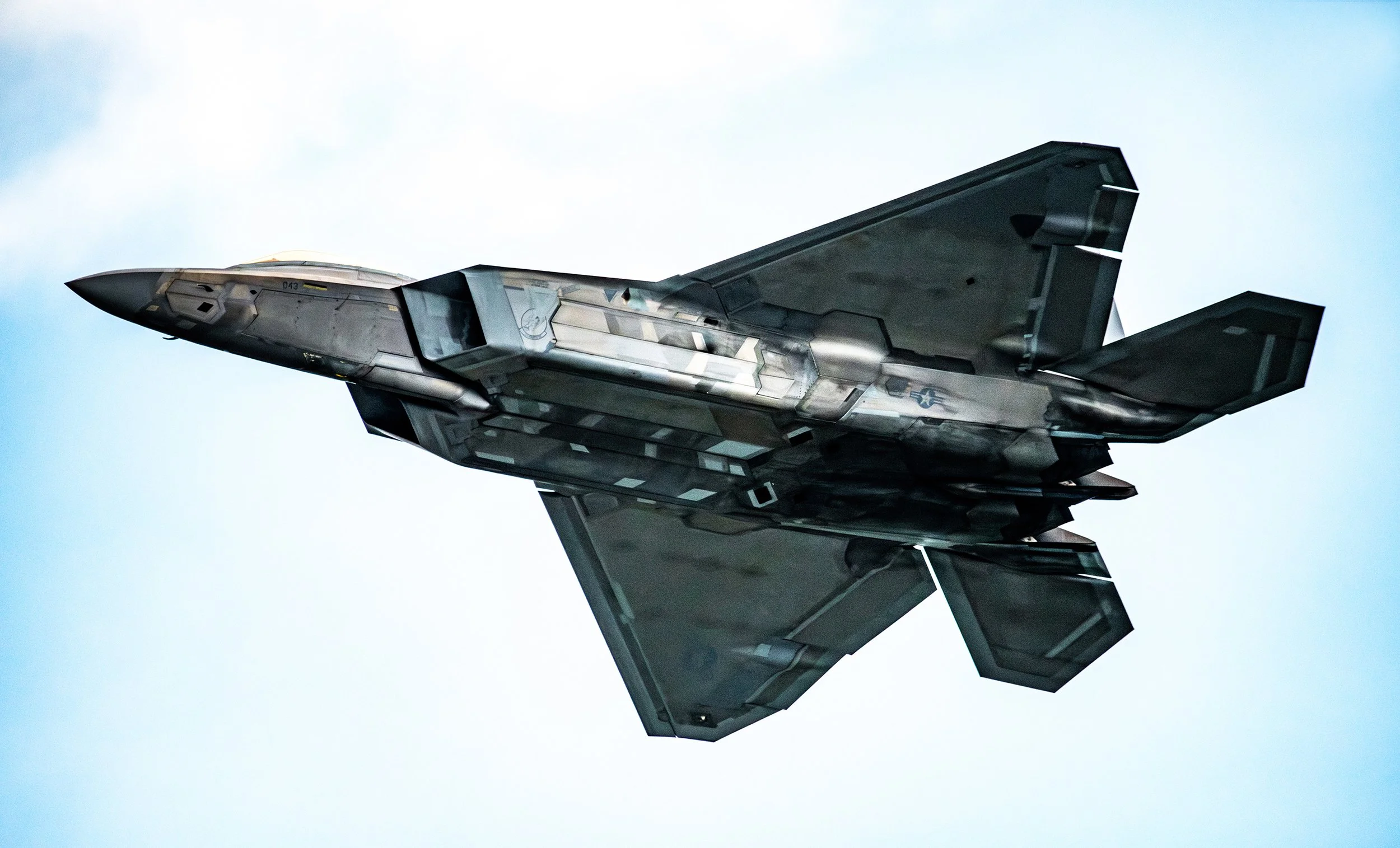 A modern fighter jet flying in the sky.