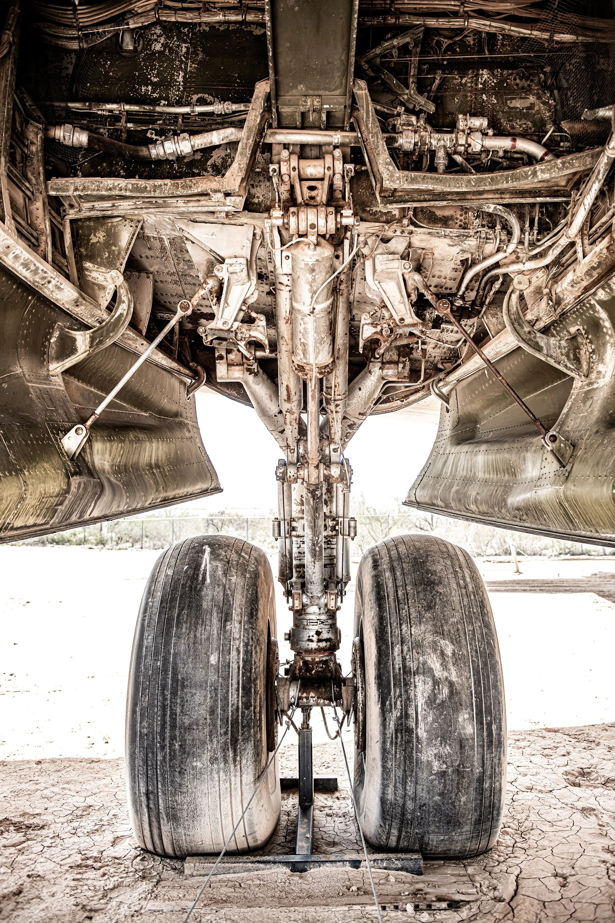 Underbelly of an aircraft showing landing gear, wheels, and mechanical components.