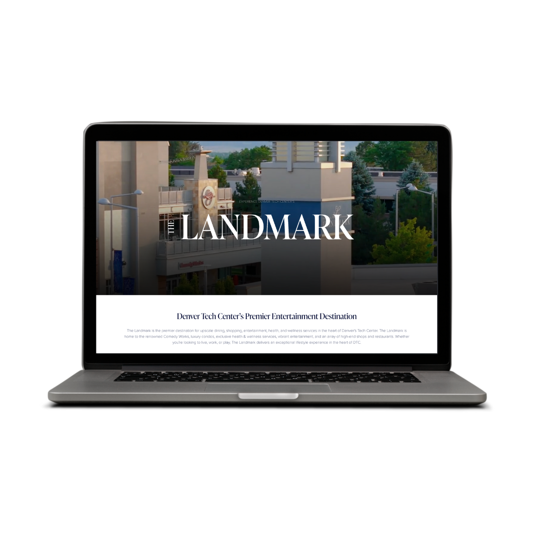 Laptop displaying a website for The Landmark, a venue at Denver Tech Center, with cityscape background