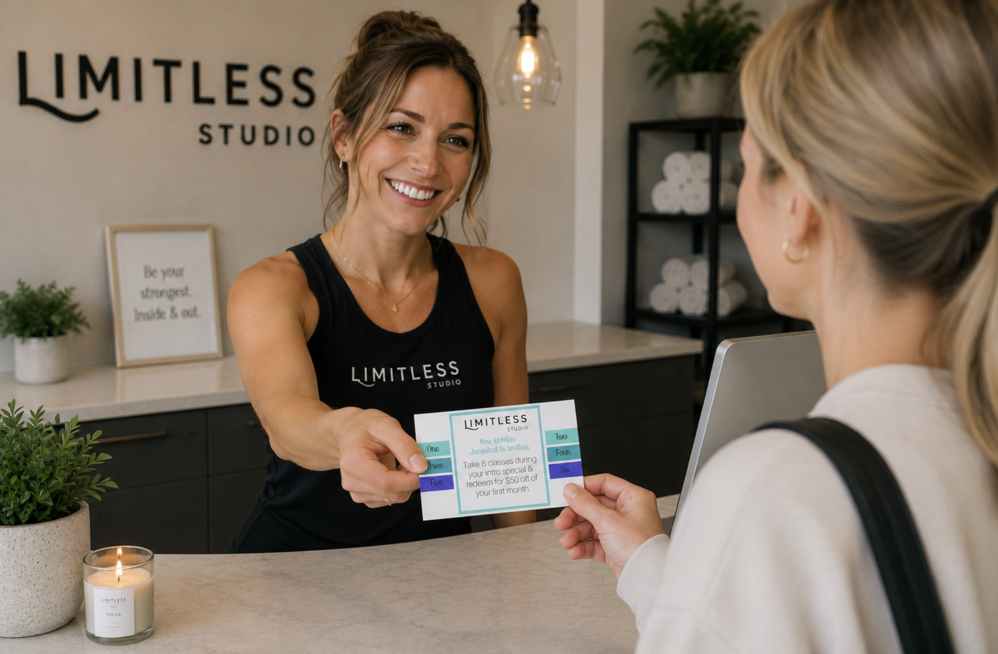 fitness studio owner handing a punchcard to a fitness client