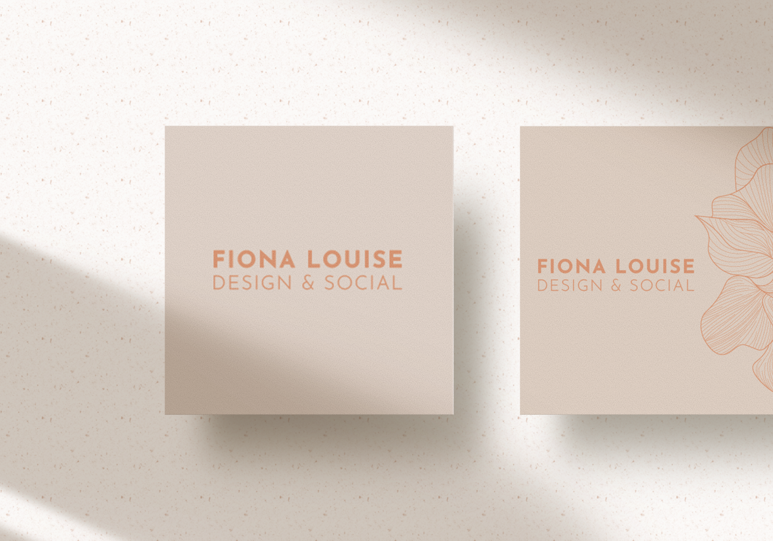Two beige business cards with "Fiona Louise Design & Social" text, one featuring floral illustration, on a light speckled background.