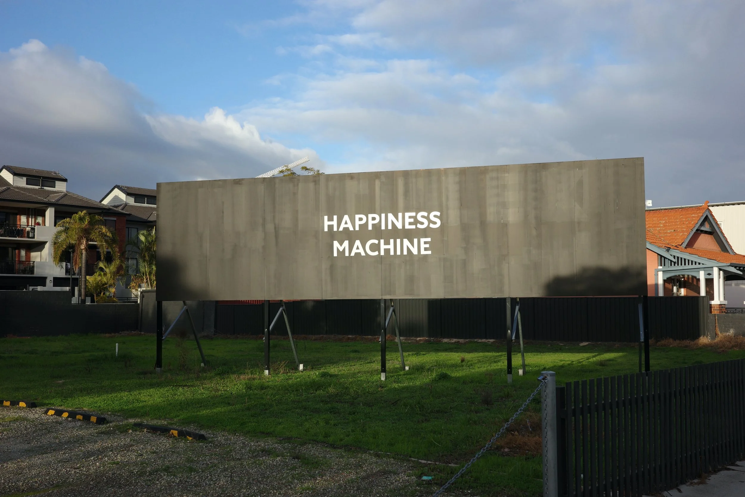 Sam Bloor, happiness machine, vinyl on disused billboard, 2024.JPG