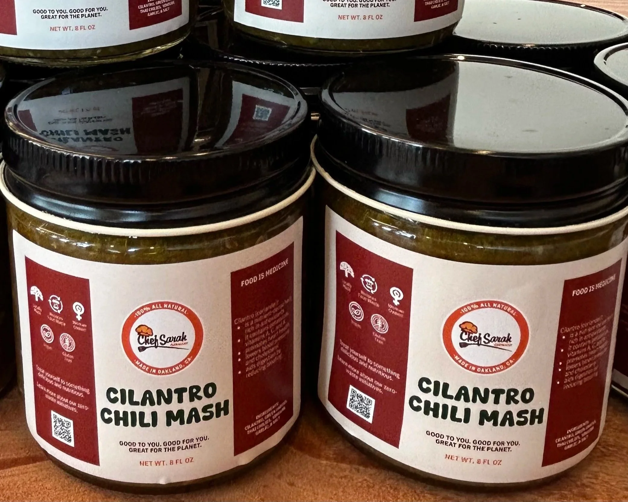 jars with labels that say cilantro chili mash and black lids