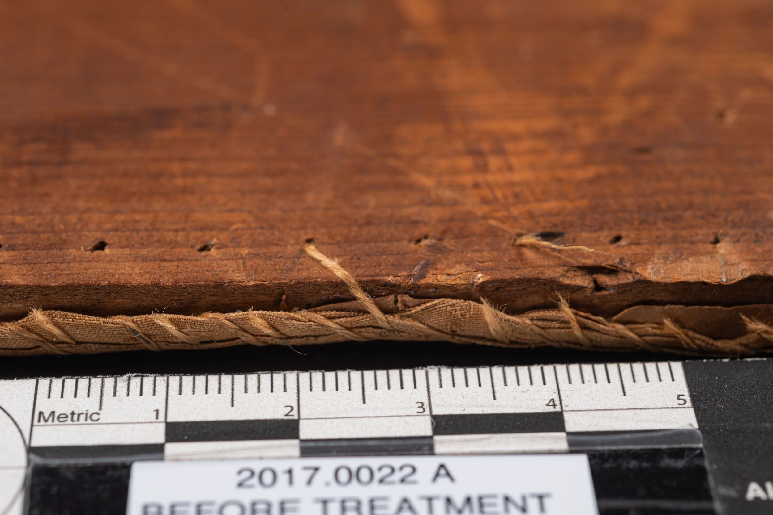 Original Stitches holding the needlework to the board