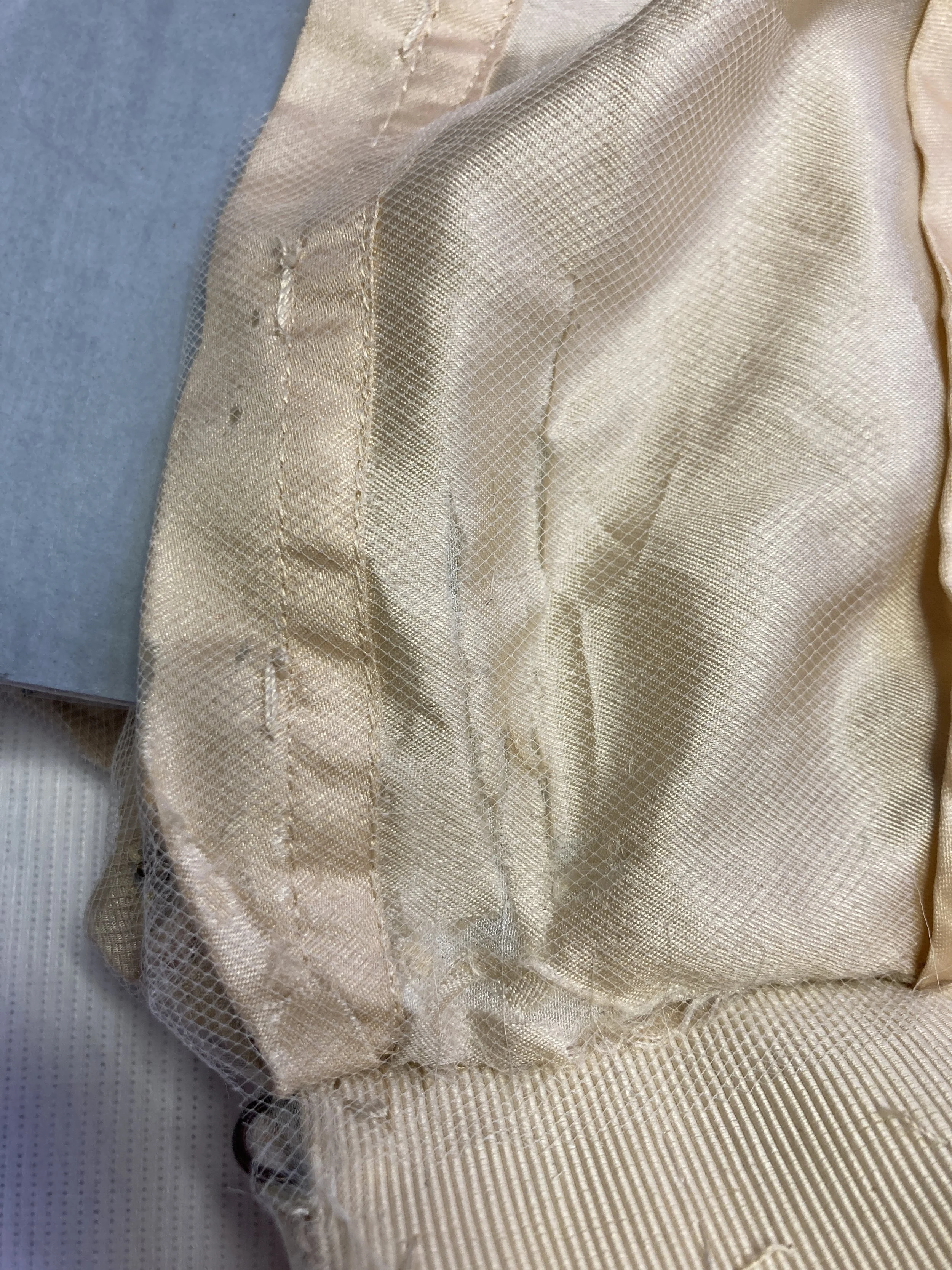 After Treatment- Silk skirt lining near center back opening consolidated with net overlay.  Photo Credit: Margaret O'Neil