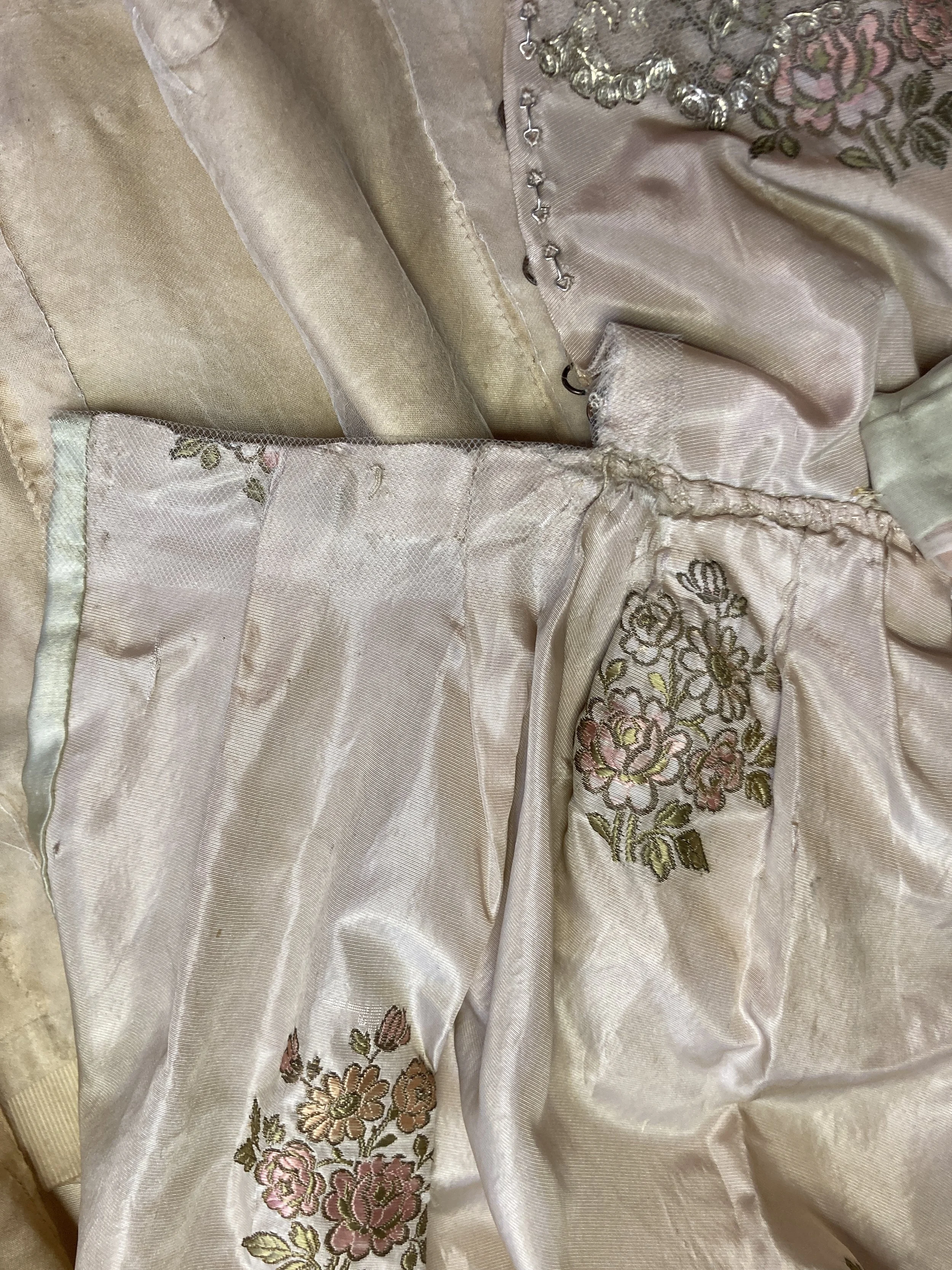 After Treatment- Back skirt bodice opening consolidated with net overlay.  Photo Credit: Margaret O'Neil