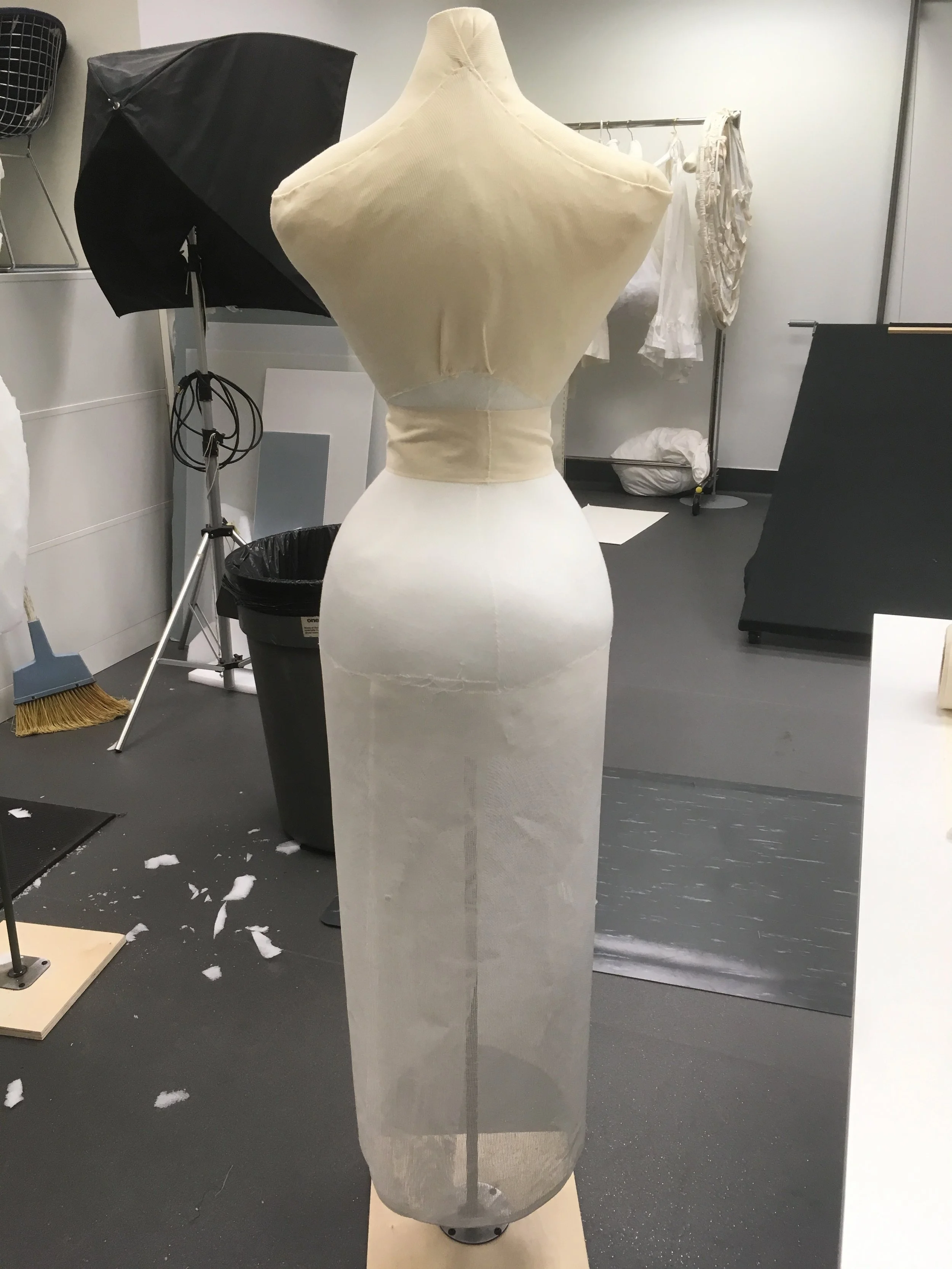 A stockinette cover was put on, a wide twill tape bound the waist, and buckram stood in for legs.