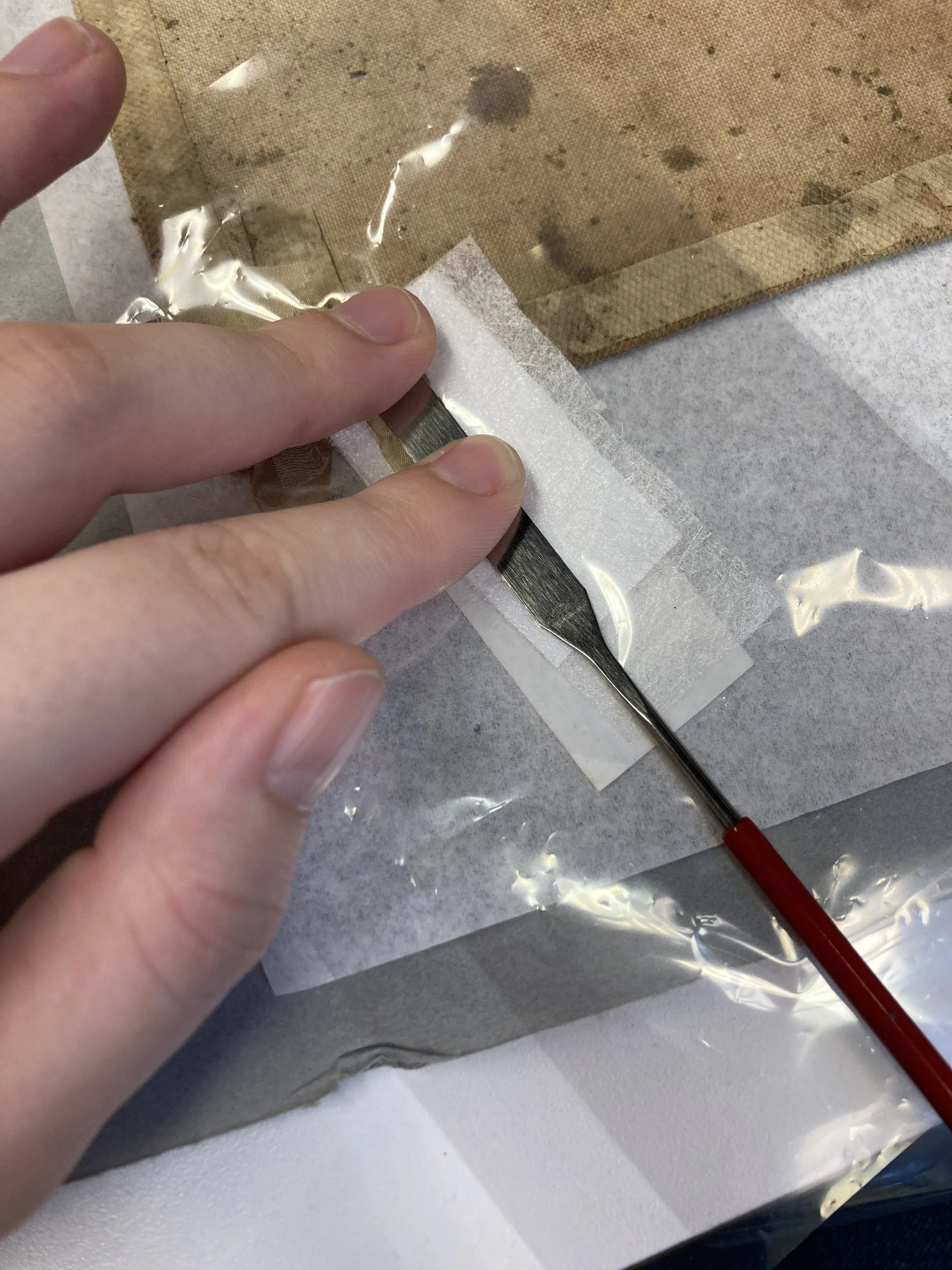 Manually putting pressure on the adhesive package with 