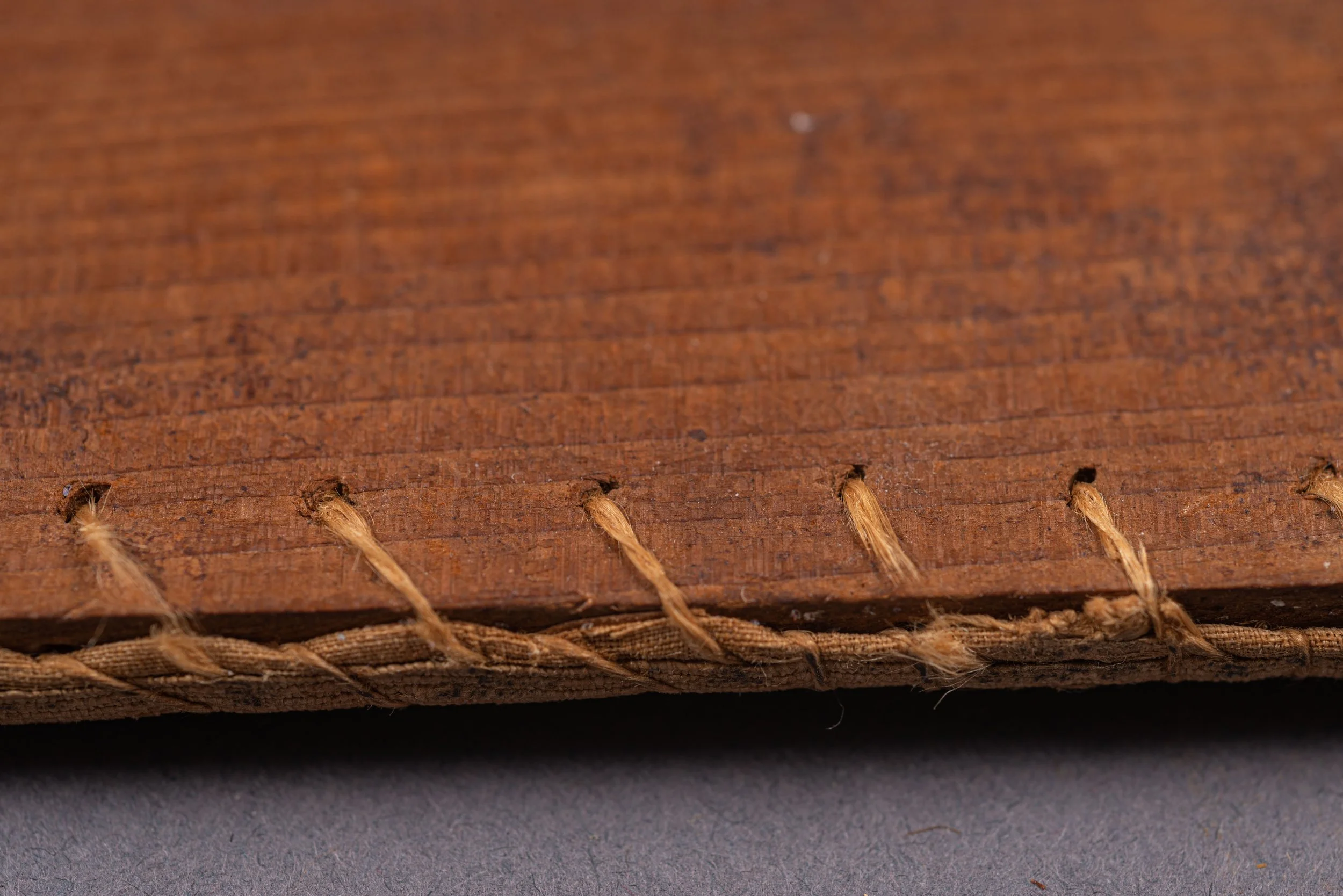 Original Stitches holding the needlework to the board