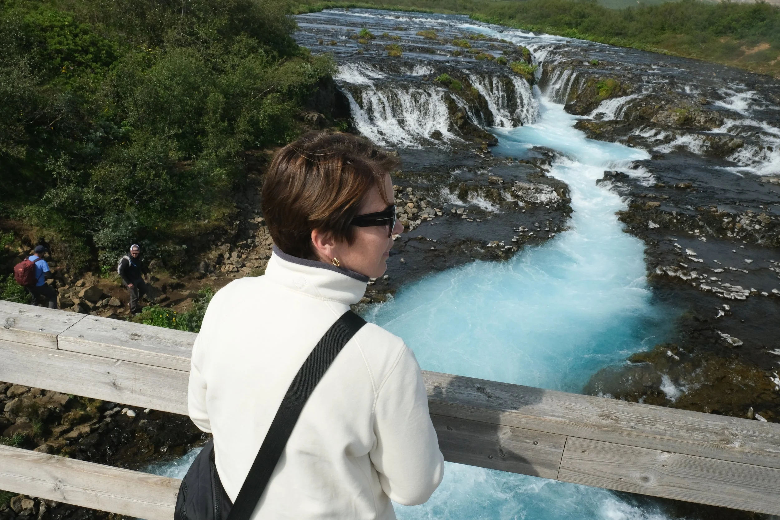 Woman with short brown hair wearing sunglasses on Þingvellir (Thingvellir) National Park