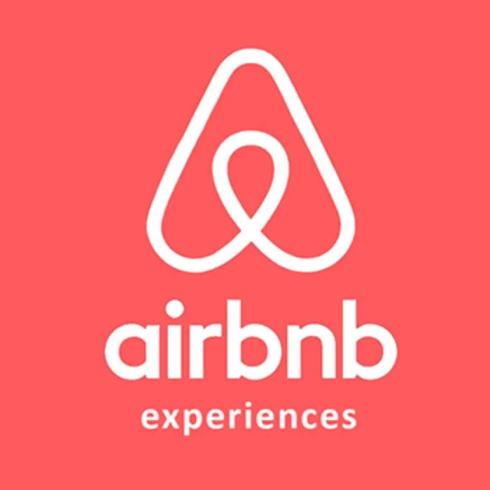 Red background with white Airbnb logo and the words "airbnb experiences".