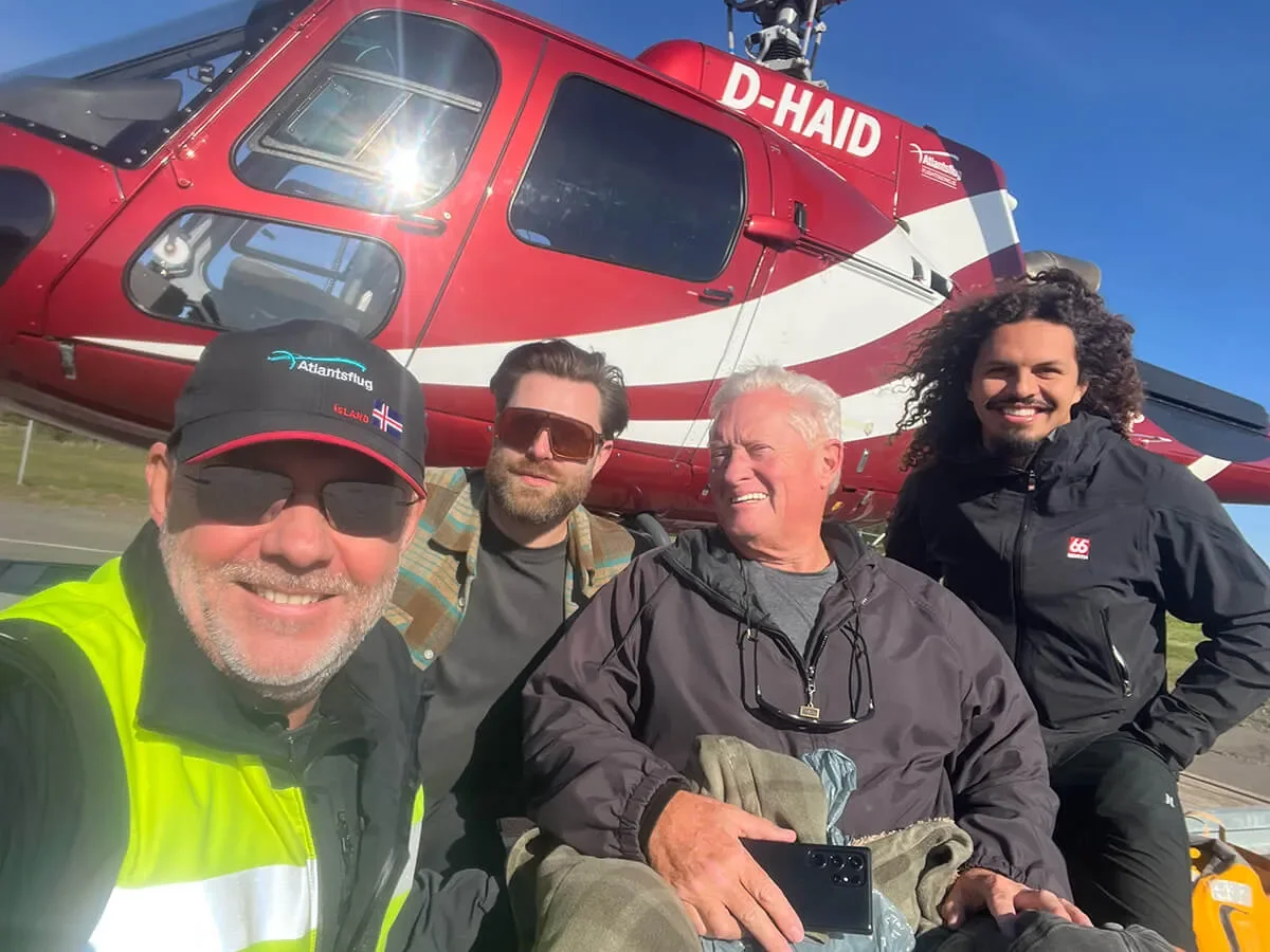 Tour group celebrating after a helicopter glacier tour in Iceland — an accessible alternative for wheelchair users who cannot reach the highland terrain by road