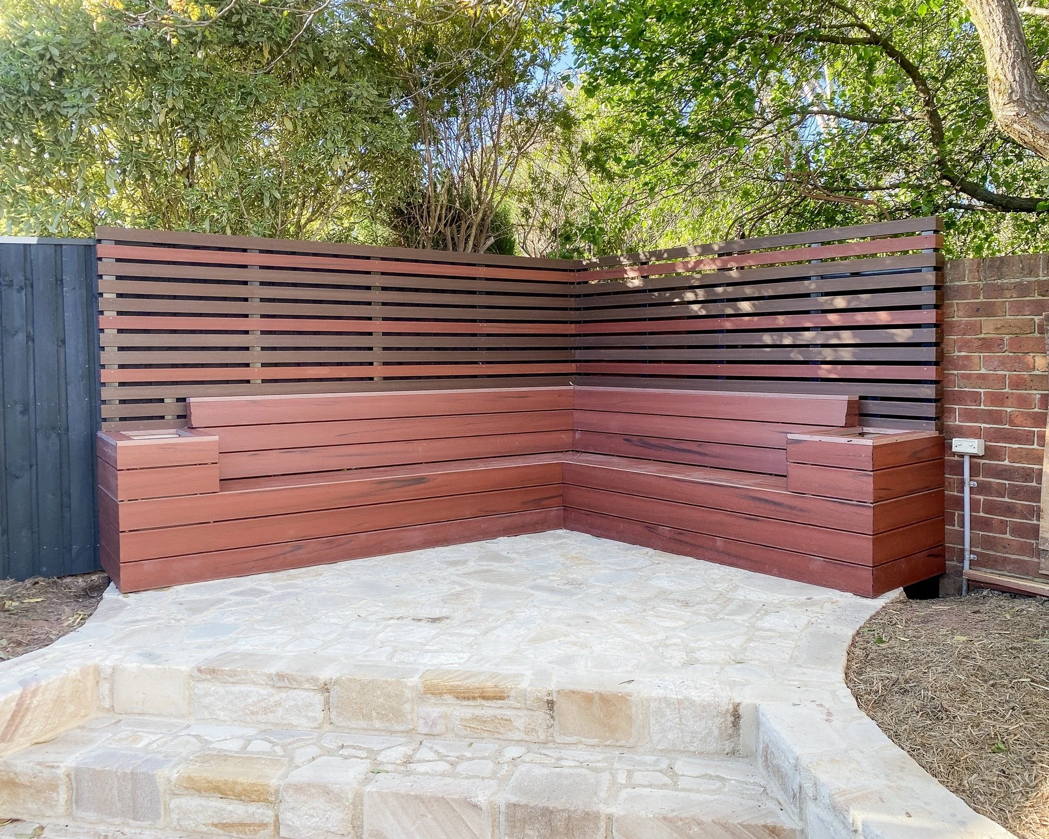 We whipped up this custom Merbau bench seat for our friends at @straight.pavescapes.

With the matching screen and built-in planter boxes how good does it look against the stone paving?!

#canberrabuilder #canberracarpentry #merbau #outdoorliving #ca