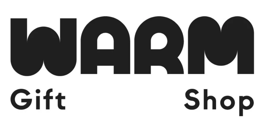 Logo for Warm Gift Shop, featuring the word 'WARM' in bold black letters, with 'Gift' on the left side and 'Shop' on the right side.