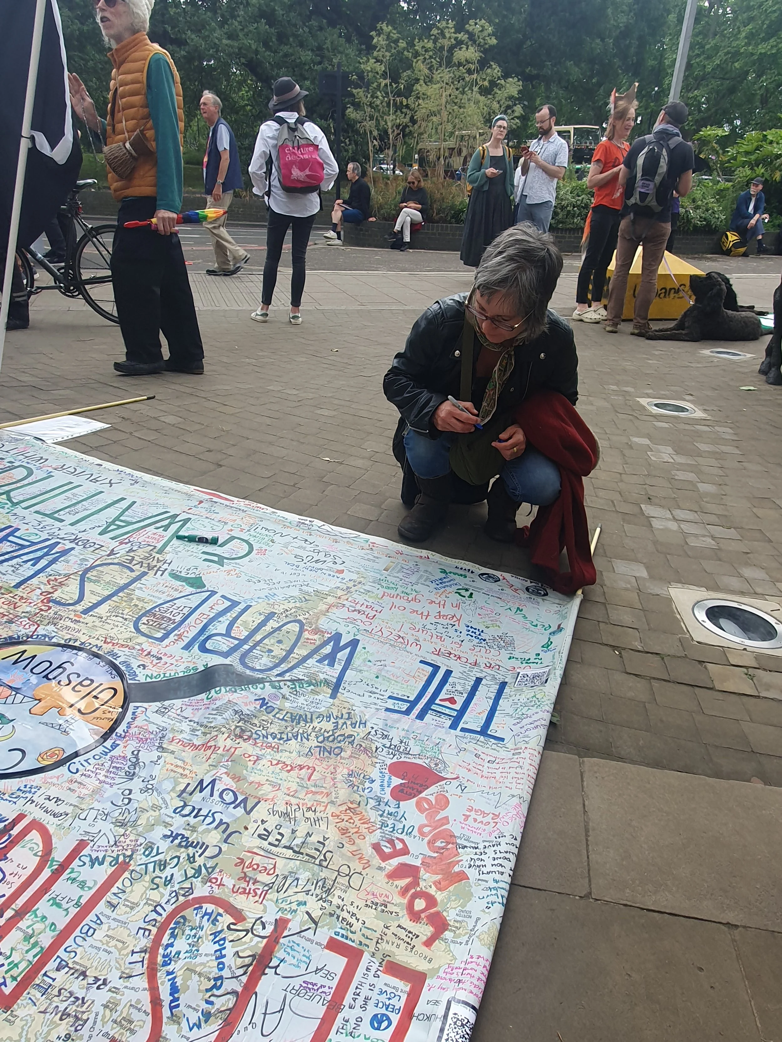 Art of regeneration member looking at a decorated world map