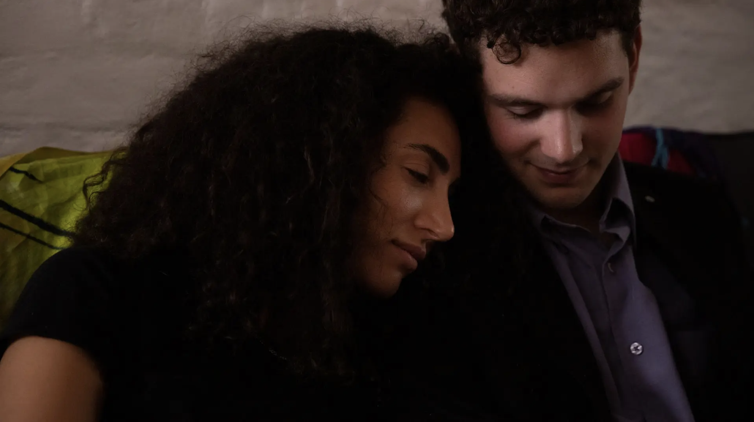 Woman (Miss Leventis) leaning on student's (Dillon's) shoulder.