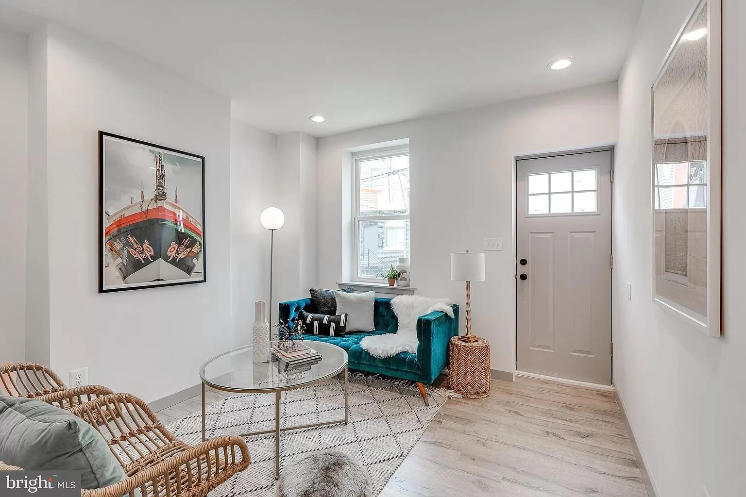 Bright, modern living room with freshly painted walls, wood flooring, and contemporary furniture.
