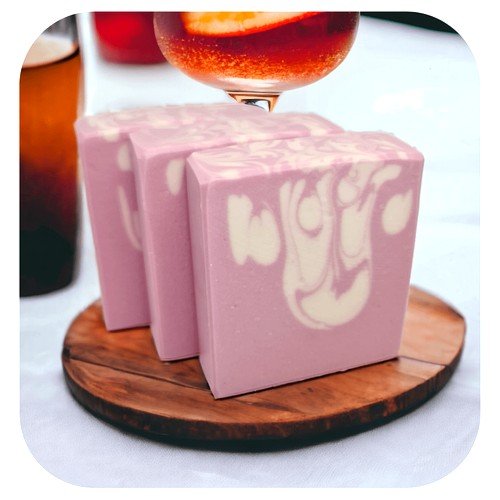 Handmade Moscato sangria soap with soft pink colour on wooden board with cocktail glass