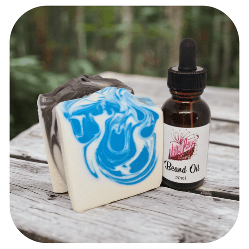 Men’s gift box with handmade soap and beard oil on wooden surface outdoors