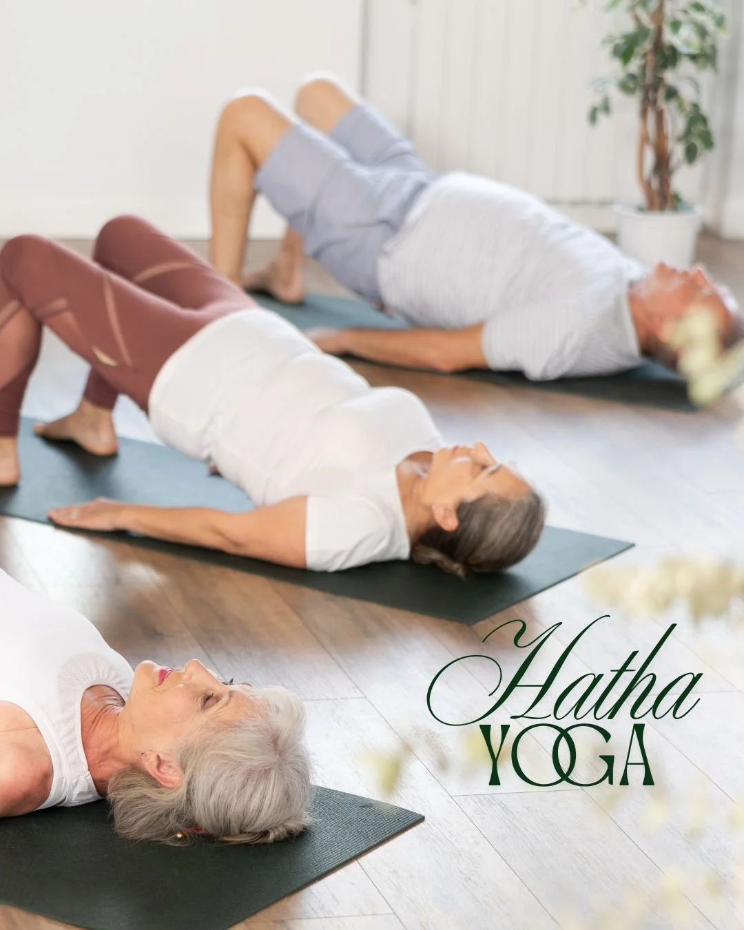 Group of adults practicing Hatha Yoga on yoga mats in a bright, peaceful studio, performing a supported bridge pose