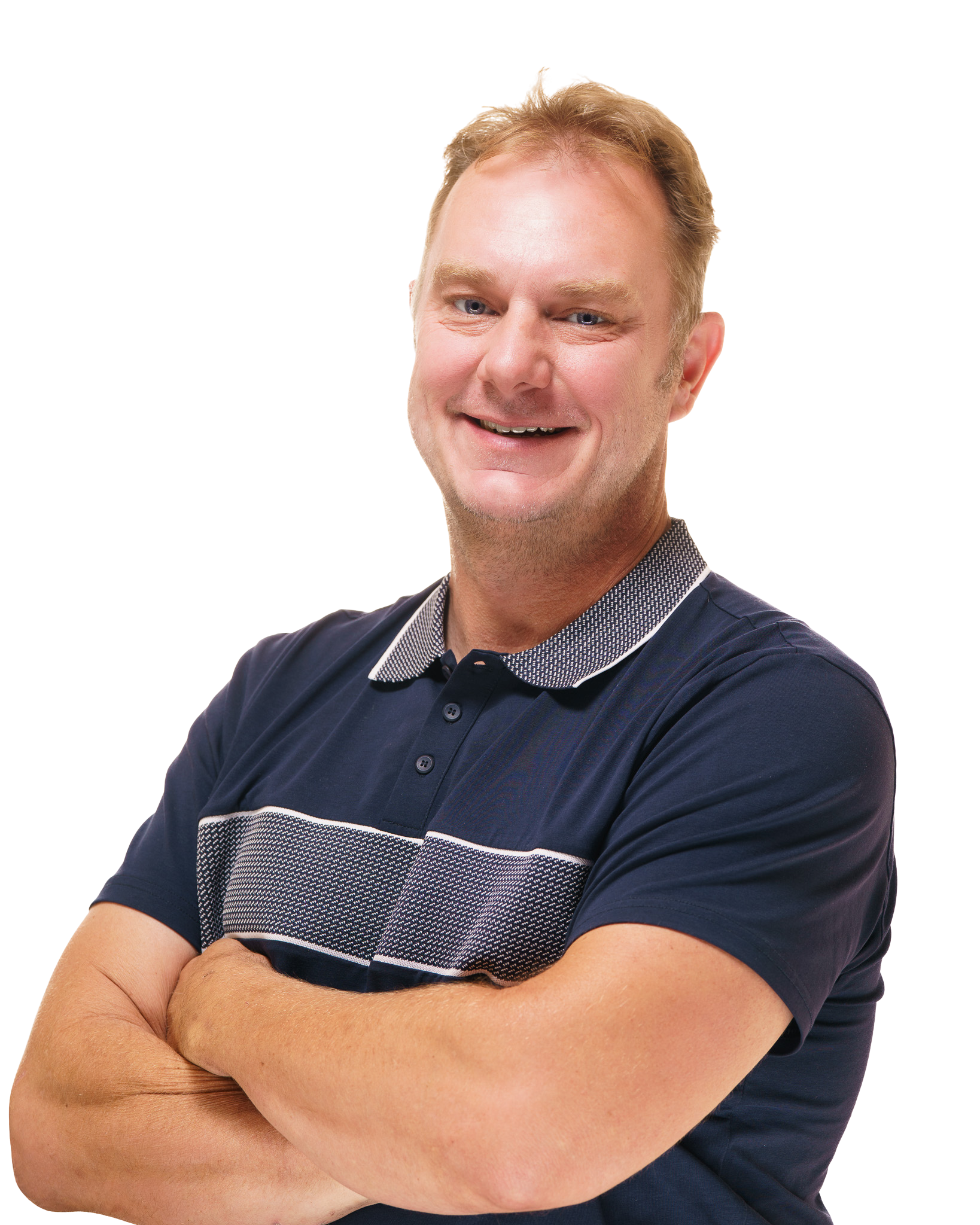 Smiling man with arms crossed wearing a navy polo shirt with a patterned collar, posing against a transparent background.