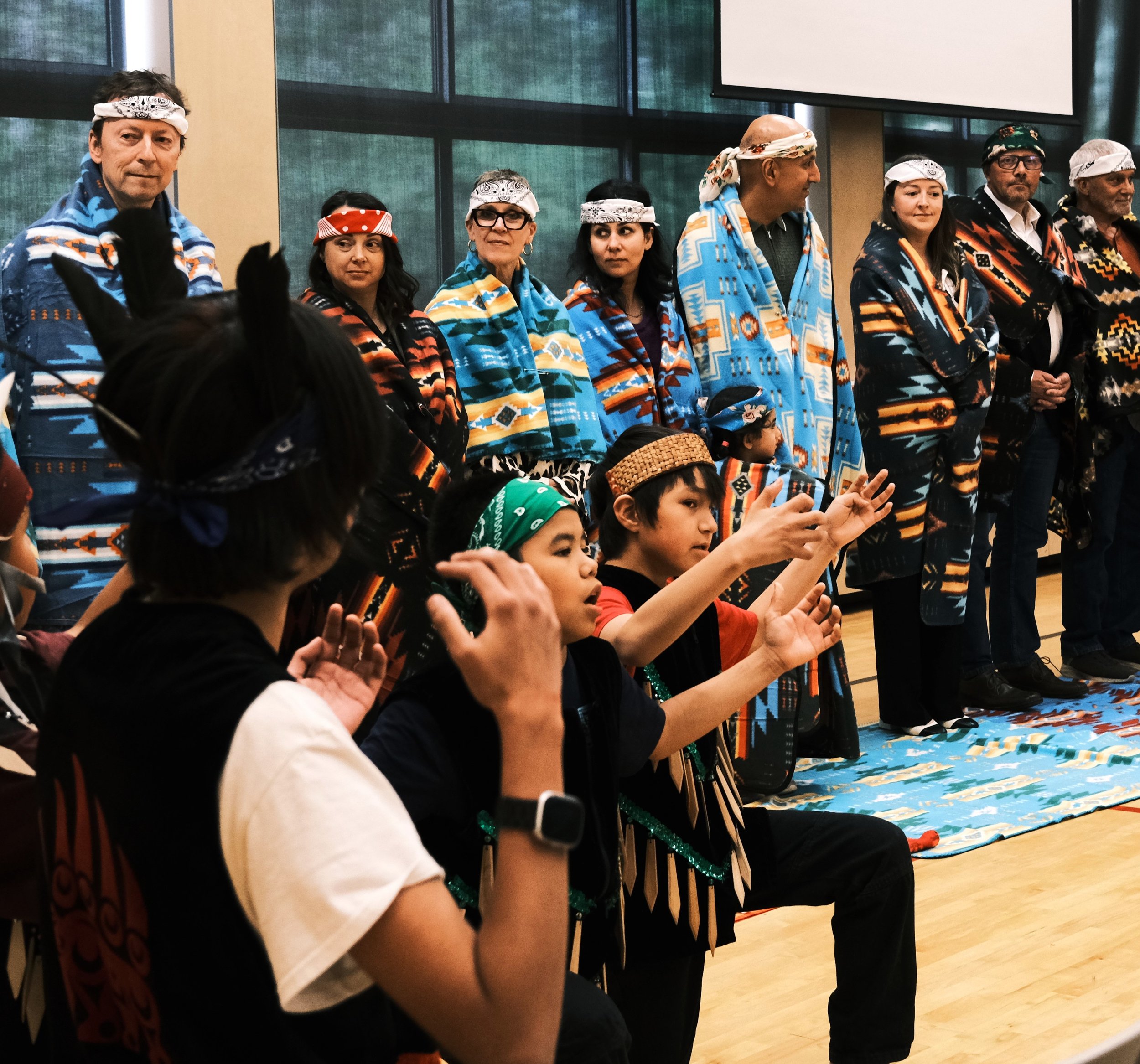 Youth raising their hands to donors.JPG