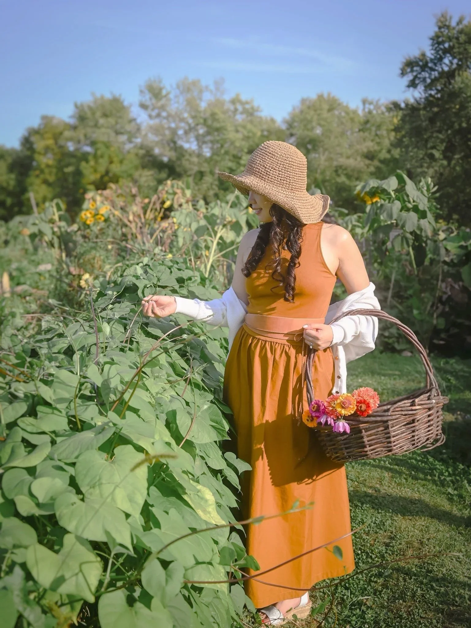 Cecille picking wildflowers with a basket in hand