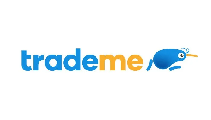 Trade Me logo with blue and orange text and a cartoon fish character