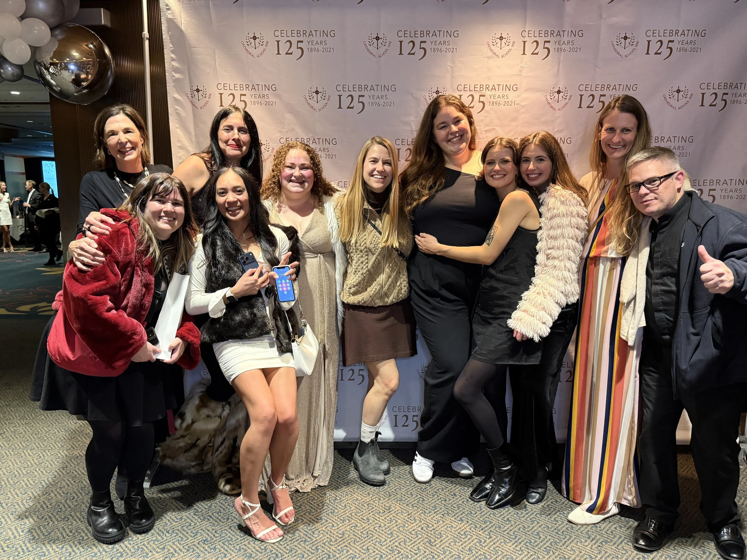 A man and woman dressed in formal attire smiling at a celebration event for Cathedral Private Catholic School In Portland.